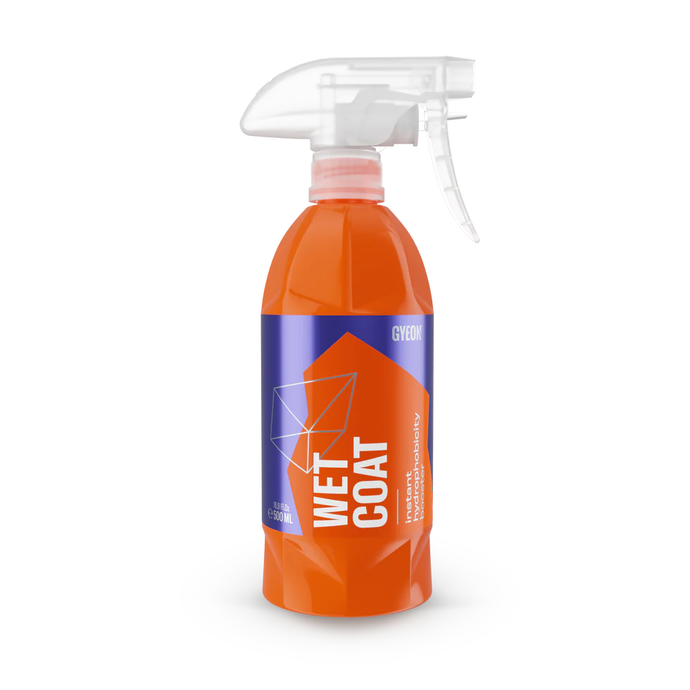 Orange spray bottle labeled 'Wet Coat' on a white background