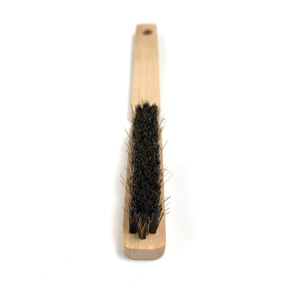 Wooden brush with black bristles on a white background