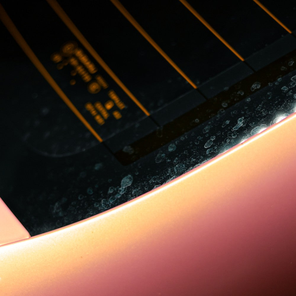 Close-up of a car windshield with hard water spots