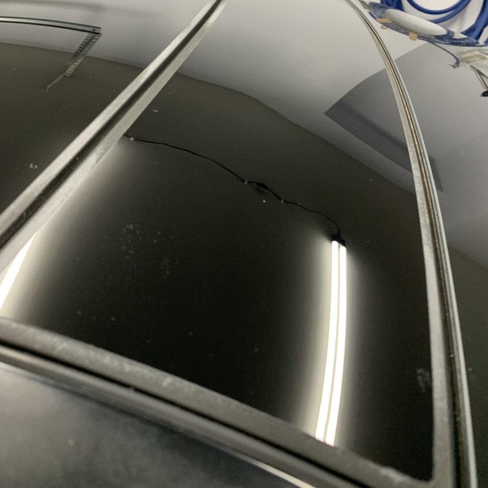 Car window after hard water spots removed from glass