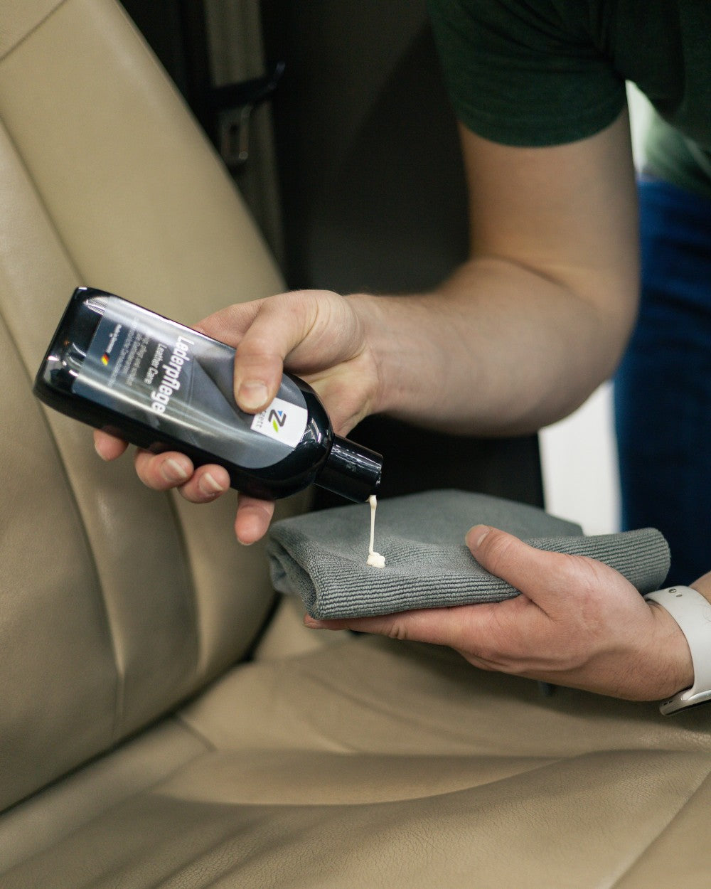 Person applying a product to a car seat with a cloth