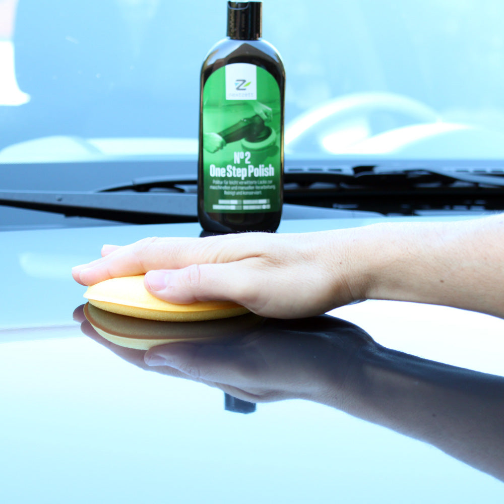 Yellow foam applicator polishing car paint